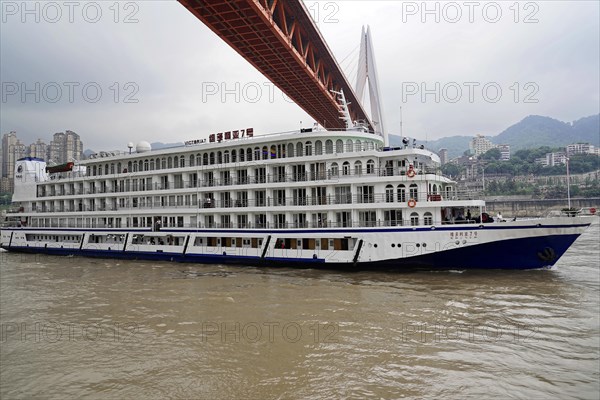 Chongqing, Chongqing Province, China, Side view of a large white cruise ship sailing on a river, Chongqing, Chongqing, Chongqing Province, China, Asia