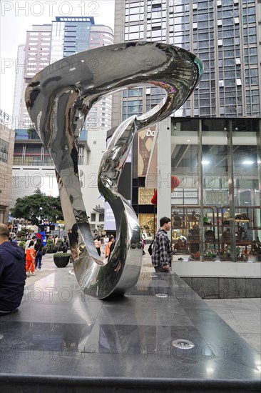 Stroll in Chongqing, Chongqing Province, China, Asia, A spiral-shaped reflective sculpture stands against an urban background, Chongqing, Asia