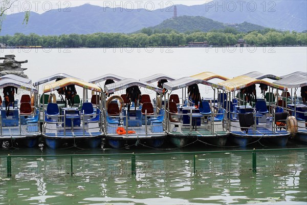 New Summer Palace, Beijing, China, Asia, Several boats on a calm lake in front of a mountain backdrop, Beijing, Asia