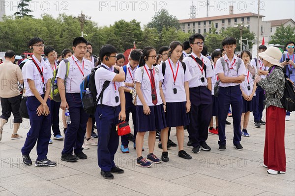 Beijing, China, Asia, school class in uniforms with medals listens to a guide during a city tour, Asia