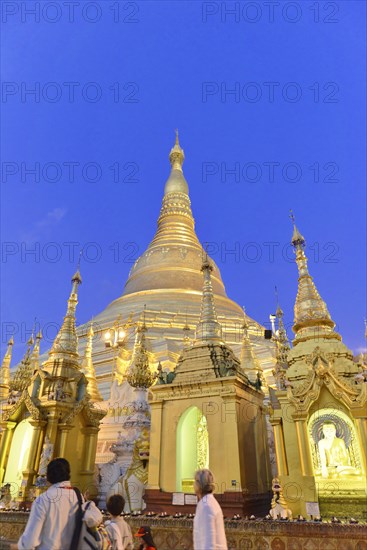 Shwedagon Pagoda, Yangon, Myanmar, Asia, People gather at the Shwedagon Pagoda as dusk colours the sky, Asia