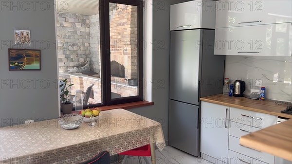 Interior of a modern kitchen with granite countertop and grey wall