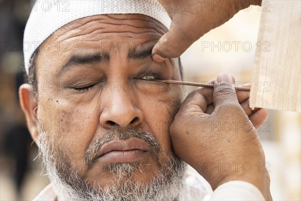 GUWAHATI, INDIA, APRIL 11: A Muslim man applies Surma on eyes during Eid Al-Fitr in Guwahati, India on April 11, 2024. Muslims around the world are celebrating the Eid al-Fitr holiday, which marks the end of the fasting month of Ramadan