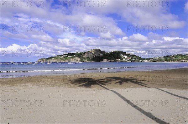 San Juan del Sur, Nicaragua, Wide beach with the shade of palm trees, rock formations in the background, Central America, Central America