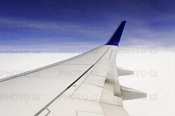 View of aeroplane wings above clouds and under clear sky, AUGUSTO C. SANDINO Airport, Managua, Nicaragua, Central America, Central America