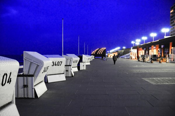 Evening, Westerland, Sylt, Schleswig-Holstein, row of beach chairs on a promenade at night with one person, Sylt, North Frisian Island, Schleswig Holstein, Germany, Europe