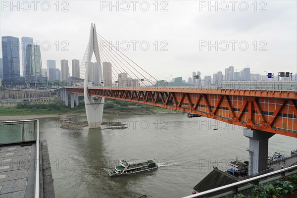Stroll in Chongqing, Chongqing Province, China, Asia, Orange bridge with city view in the background and slightly cloudy sky, Chongqing, Asia