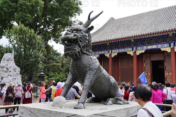 New Summer Palace, Beijing, China, Asia, Visitors admire an imposing stone sculpture of a mythical creature in front of a temple, Beijing, Asia