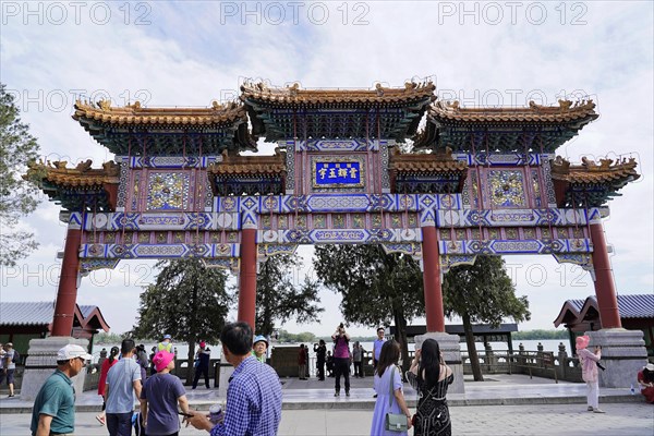 New Summer Palace, Beijing, China, Asia, Visitors enter an area through an elaborately decorated traditional Chinese gate, Beijing, Asia