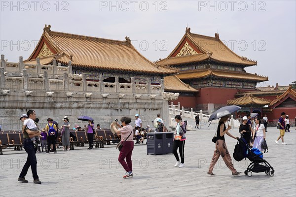 China, Beijing, Forbidden City, UNESCO World Heritage Site, Visitors walk across a wide square in front of imperial Chinese architecture, Forbidden City (Palace Museum) in Beijing, China, Asia
