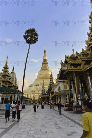 Shwedagon Pagoda, Yangon, Myanmar, Asia, View of the Shwedagon Pagoda at dusk, people walking on a wide path, Asia