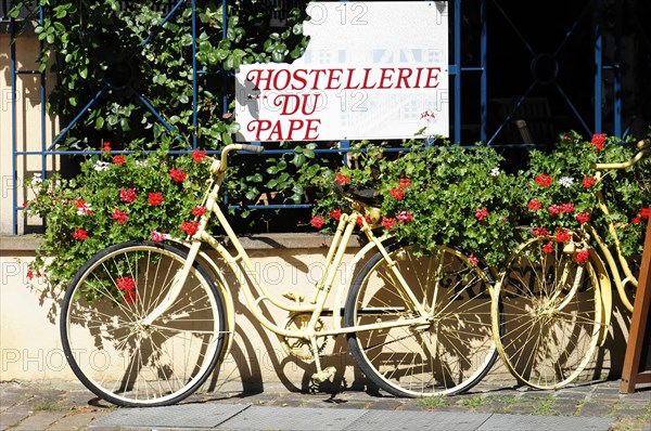 Eguisheim, Alsace, France, Europe, Yellow bicycle with flower decoration in front of 'Hostellerie du Pape', Europe