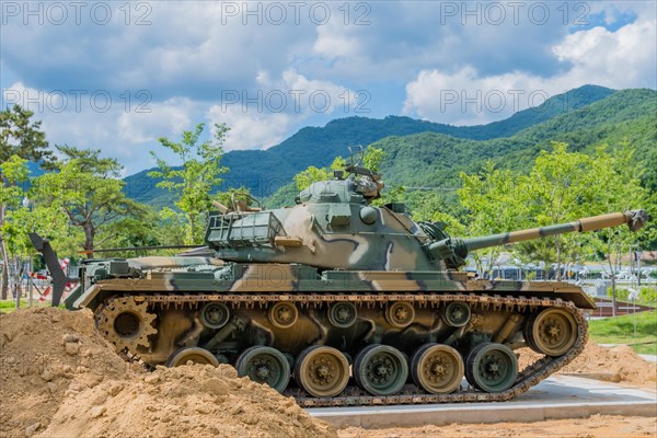 Side view of camouflaged tank used in Korean war on display in public park in Nonsan, South Korea, Asia