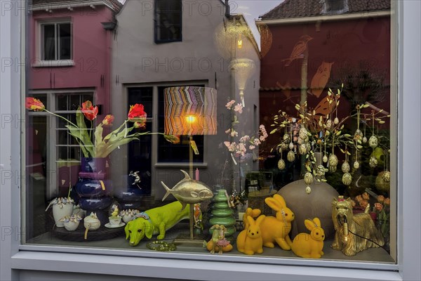 Whimsically decorated shop window with reflection, decoration, idiosyncratic, funny, colourful, shrill, shopping, retail, retail trade, city, city centre, shop, shop, furnishing, lamp, dachshund, Easter, Easter bunny, decorated, design, Dutch, Deventer, Netherlands