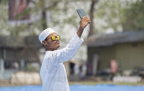 GUWAHATI, INDIA, APRIL 11: A Muslim person takes selfie after perform Eid al-Fitr prayer at Eidgah in Guwahati, India on April 11, 2024. Muslims around the world are celebrating the Eid al-Fitr holiday, which marks the end of the fasting month of Ramadan