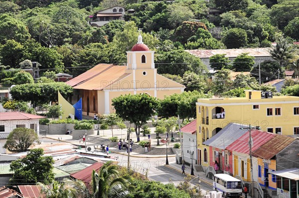 San Juan del Sur, Nicaragua, Municipal square with a church in the centre, surrounded by colourful buildings and nature, Central America, Central America