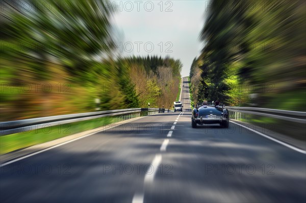 Zoom effect, country road near Boerwang with old MG sports car, Allgaeu, Swabia, Bavaria, Germany, Europe