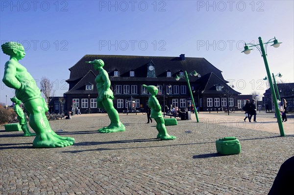 Westerland, North Sea island of Sylt, North Frisia, Schleswig-Holstein, Large green statues in front of a railway station building with people walking around, Sylt, North Frisian island, Schleswig-Holstein, Germany, Europe