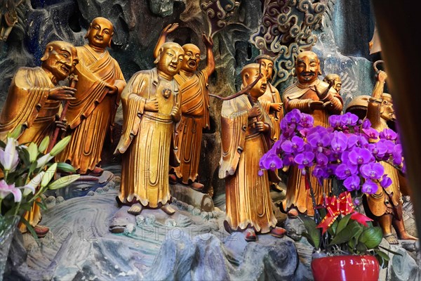 Jade Buddha Temple, Buddha, Puxi, Shanghai, Shanghai Shi, China, Smiling religious statues surrounded by colourful flowers in harmonious arrangement, Shanghai, People's Republic of China, Asia
