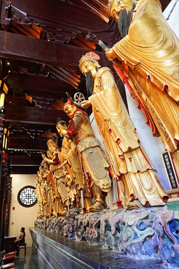 Jade Buddha Temple, Shanghai, group of carved Buddha statues and wall relief in wood-panelled temple room, Shanghai, China, Asia