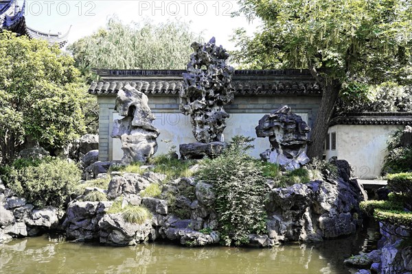 Excursion to Zhujiajiao Water Village, Shanghai, China, Asia, rock garden with traditional sculptures and dense greenery offers a peaceful retreat, Asia