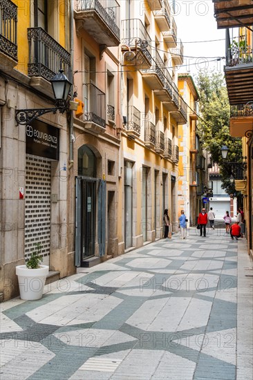 Narrow streets with shops in the city centre of Figueras, Spain, Europe