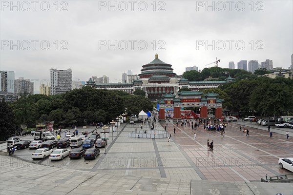 Chongqing, Chongqing Province, China, Asia, View of a busy square in front of a city hall in an urban environment under a cloudy sky, Asia
