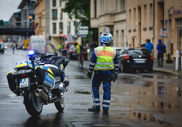 Policewoman with motorbike blocks road, taken during a demonstration in Berlin, 19/04/2024