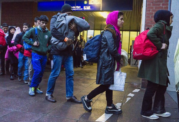 Refugees have arrived at Schoenefeld station on an IC train. They are then taken by bus to accommodation in Berlin, 02.12.2015, Schoenefeld, Brandenburg, Germany, Europe