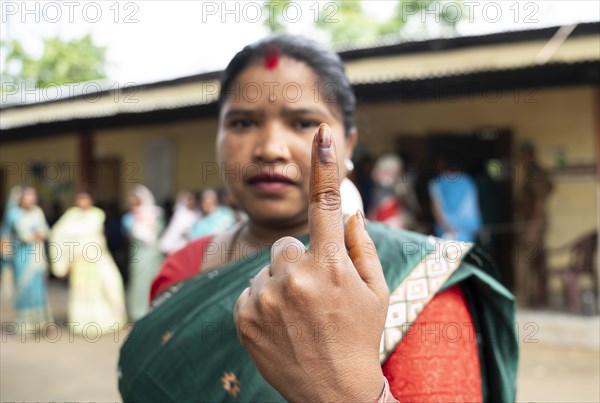 BOKAKHAT, INDIA, APRIL 19: A women show her marked finger after casting vote during the first phase of the India's general elections on April 19, 2024 in Bokakhat, Assam, India. Nearly a billion Indians vote to elect a new government in six-week-long parliamentary polls starting today