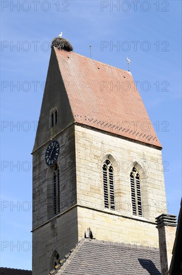 Eguisheim, Alsace, France, Europe, A church tower with a stork's nest on top under a clear blue sky, Europe