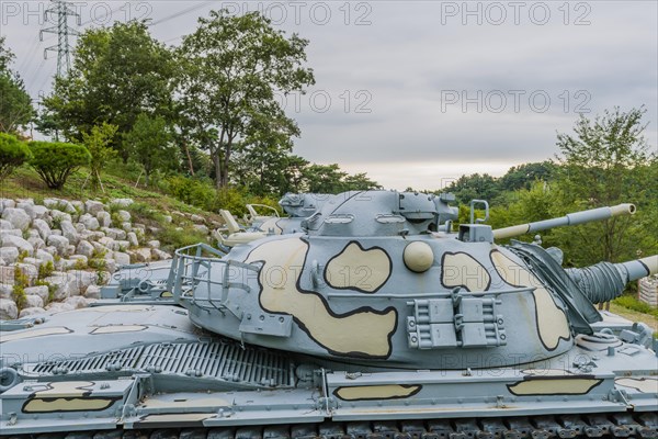 Closeup of gun turret on military tank with camouflage paint on display in public park in Nonsan, South Korea, Asia