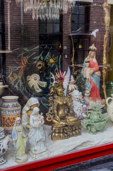 Display window with various religious sculptures, religion, Christianity, Hinduism, Buddha, Buddhism, different, world religion, culture, mixture, mixed, multicultural, multicultural, diversity, decoration, church, icon, deity, God, faith, faith war, tolerance, statues, image