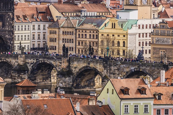 Figures of saints, crowds of people, Charles Bridge, stone bridge, view of Prague Castle, Prague 2024