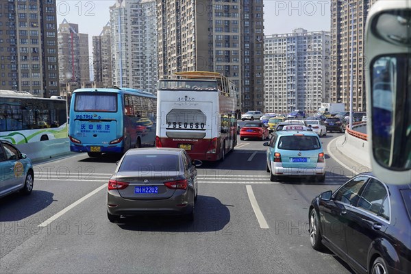 Traffic in Shanghai, Shanghai Shi, People's Republic of China, Dense traffic with buses and cars in an urban environment during daylight, Shanghai, China, Asia