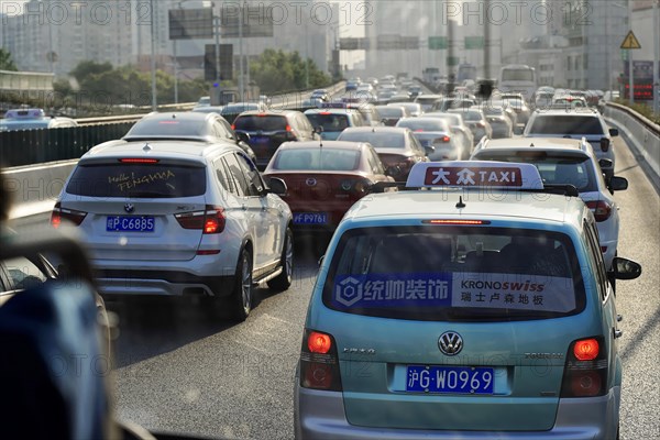 Shanghai, People's Republic of China, Dense traffic with many cars on a city street in sunny weather, Shanghai, China, Asia