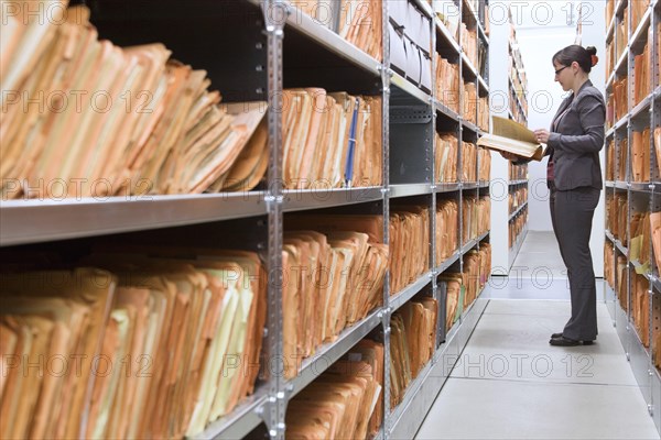 An employee of the Federal Commissioner for the Records of the State Security Service of the former German Democratic Republic, BStU, looks at Stasi files. Files and documents of the Ministry for State Security of the GDR are stored in the Stasi Records Authority, 17.01.2015., Berlin, Berlin, Germany, Europe