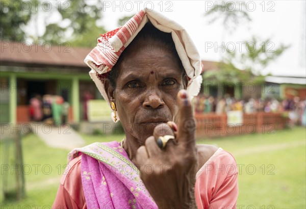 BOKAKHAT, INDIA, APRIL 19: A women show her marked finger after casting vote during the first phase of the India's general elections on April 19, 2024 in Bokakhat, Assam, India. Nearly a billion Indians vote to elect a new government in six-week-long parliamentary polls starting today