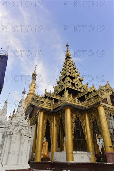 Shwedagon Pagoda, Yangon, Myanmar, Asia, Golden temple with complex decorations under a blue sky with white clouds, Asia
