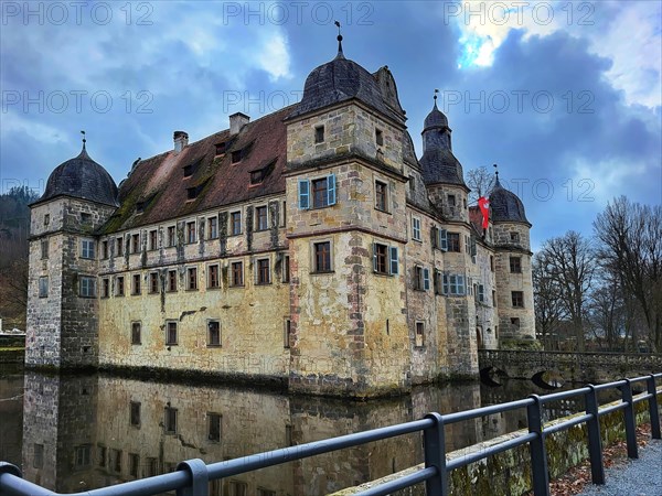 Mitwitz moated castle under a cloudy sky. Mitwitz, Kronach, Upper Franconia, Bavaria, Germany, Europe