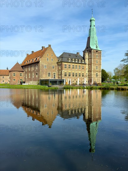 View over moat to historic moated castle from Renaissance Raesfeld Castle reflected in moat in spring, excursion destination in North Rhine-Westphalia, Freiheit Raesfeld, Muensterland, North Rhine-Westphalia, Germany, Europe