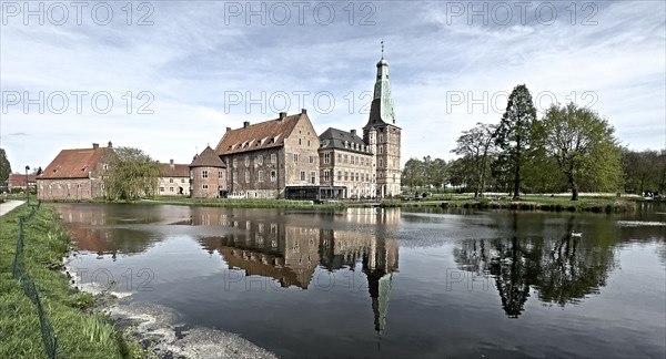 Panoramic photo with reduced dynamic colours in style of old historical photo showing view over wide moat on historical moated castle from Renaissance Raesfeld Castle reflected in moat in spring, Freiheit Raesfeld, Muensterland, North Rhine-Westphalia, Germany, Europe