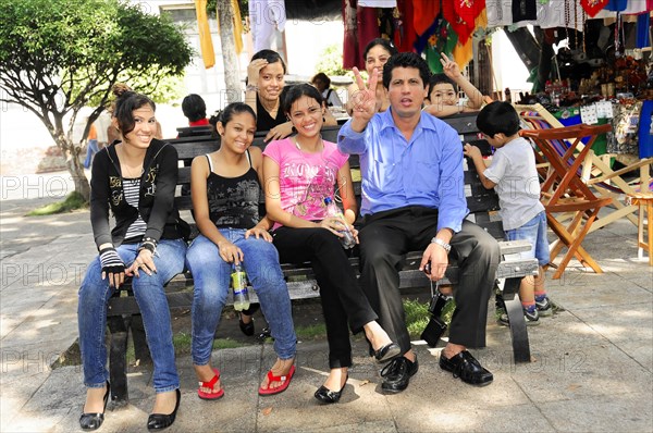 Leon, Nicaragua, Group of people of different ages sitting on a bench smiling, Central America, Central America