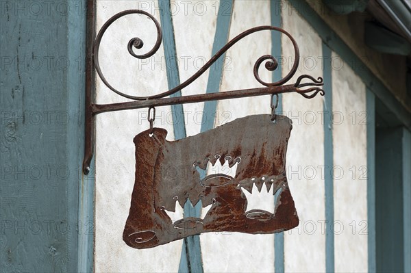 Old nose sign of a former Three Crowns inn, on a half-timbered house, Langeais, France, Europe