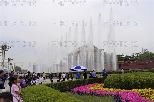 China, Beijing, Forbidden City, UNESCO World Heritage Site, A crowd visits a tourist attraction on a cloudy day with fountains, Asia