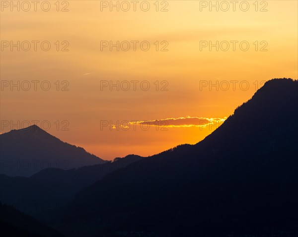 Sunset over mountain peaks, clouds in the evening light after sunset, view from the lowlands, Leoben, Styria, Austria, Europe