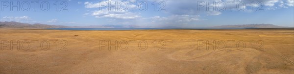 Aerial view, Vast empty landscape at the mountain lake Song Kul in autumn, Moldo Too Mountains, Naryn region, Kyrgyzstan, Asia