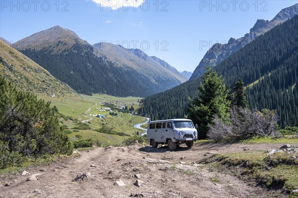 UAZ Buchanka, Russian off-road vehicle on 4x4 track, green mountain valley with village Altyn Arashan, Tien Shan Mountains, Kyrgyzstan, Asia