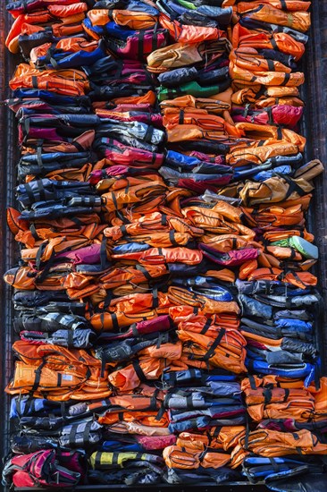 Colourful stacked migrant lifejackets exhibition called Soleil Levant by Chinese artist Ai Weiwei, Nyhavn, Copenhagen, Denmark, Europe