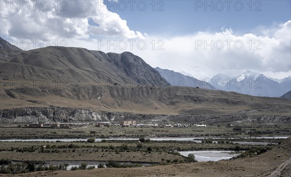 Abandoned buildings in a barren landscape, ghost town of Enilchek in the Tien Shan Mountains, Ak-Su, Kyrgyzstan, Asia